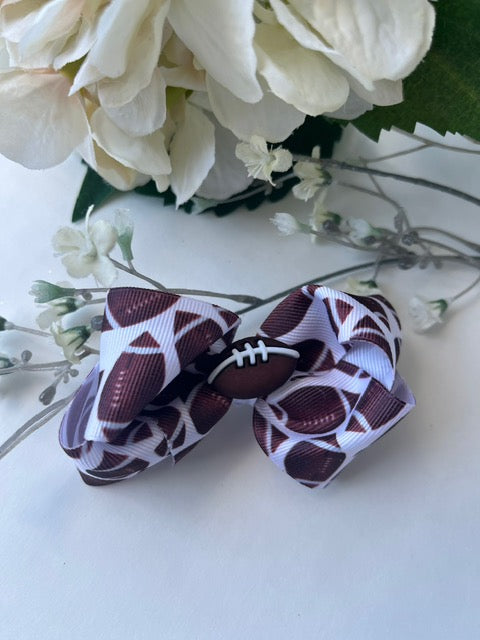 Football print twisted boutique clip in hair bow